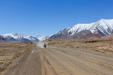 road in the mountains with alone biker