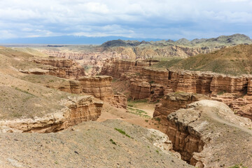 a canyon with a river and small vegetation in Central Asia at daytime