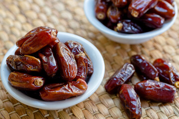 Fresh red dates (hurma) in bowl 