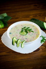 summer cucumber soup with vegetables on a wooden table