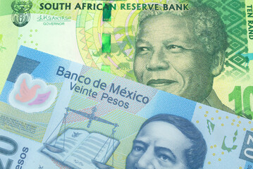 A green ten rand note from South Africa close up in macro with a blue twenty Mexican peso bank note