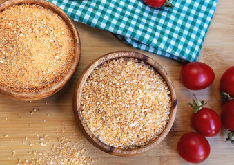 Turkish traditional tarhana (uncooked) and tomatoes on wooden background
