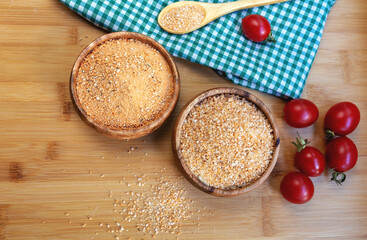 Turkish traditional tarhana (uncooked) and tomatoes on wooden background
