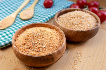 Turkish traditional tarhana (uncooked) and tomatoes on wooden background