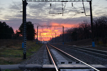 Fototapeta na wymiar Empty railroad track in sunny summer sunset