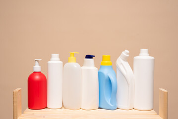 Various detergent bottles on the store counter on the light background with copy space.