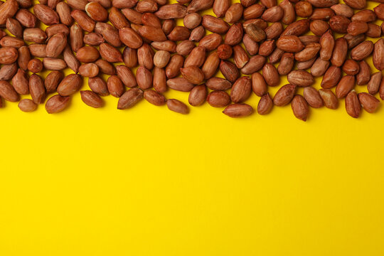 Tasty peanut on yellow background, space for text. Vitamin food