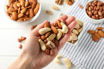 Female hand holds different nuts. Healthy eating