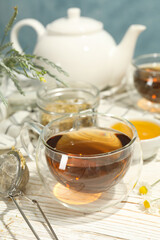 Composition with chamomile tea on white wooden table