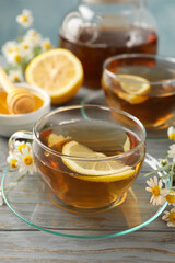 Composition with chamomile tea on gray wooden background