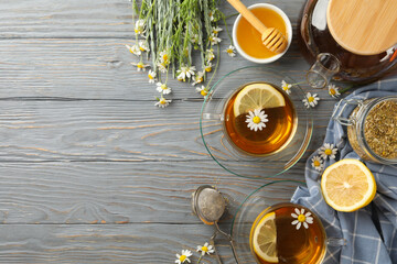 Composition with chamomile tea on gray wooden background