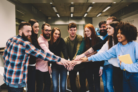 Diversity Group Of Happy Dream Team Members Standing Together And Celebrating Successfully Completed Business Startup Project.Prosperous Young Crew Of IT Professionals Enjoying Free Time In Office