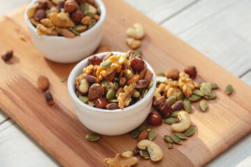 A mix of dried fruit in bowl on wooden background.
