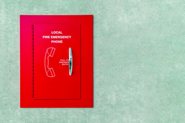 Red box of fire emergency phone. Red box emergency phone on the wall. Telephone Fire Alarm.