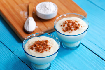 Homemade Turkish custard with cinnamon, Turkish muhallebi on wooden background