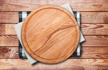 Fototapeta na wymiar Empty vintage pizza board and napkin on planks.