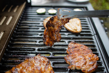 pork neck grilled on a gas grill. Closeup