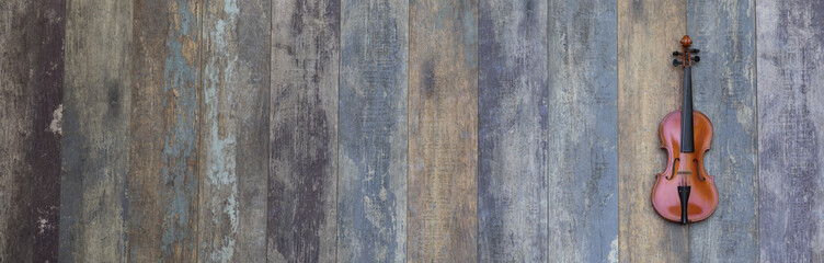 vintage violin on old wooden background