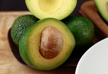 Avocado on wooden table. Selective focus