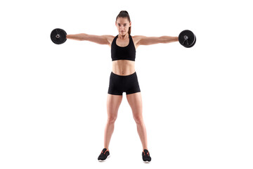 Young athletic woman working out with dumbbells