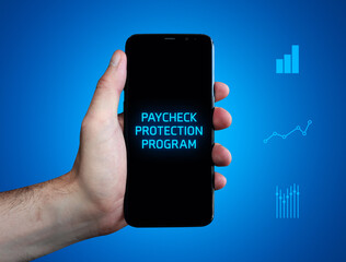 Paycheck Protection Program. Hand holds phone (cell phone). Word on display. Charts on blue background. Business