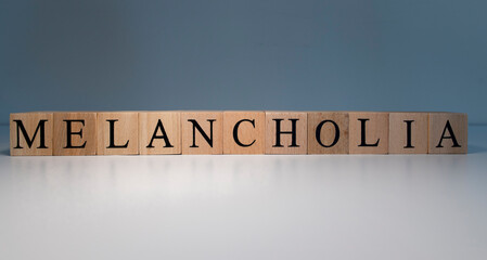 Text of melancholia from wooden cubes. psychological terms and health problems.