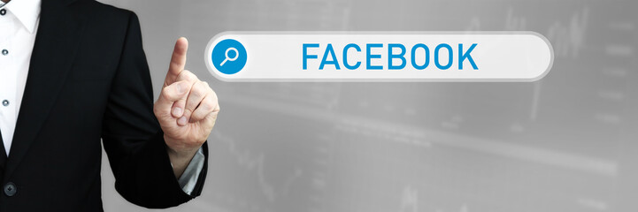 Facebook. Businessman (Man) in a suit pointing with his finger to a search box. The word is in focus. Blue Background. Business, Finance, Statistics, Analysis, Economy