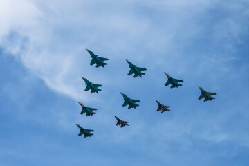 Naklejka na ściany i meble Military planes aerobatic group in the sky