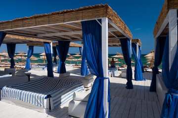VIP pavilion on a beach. Сomfy and luxury tent or pergola for privacy and vip service on a vacation.
