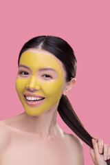 Confident woman using new organic facial mask