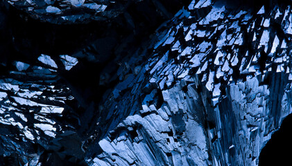 Blue Pyrite mineral on a black background, close up. Mineral stone pattern and texture. Selective...
