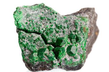 macro stone mineral uvarovite on a white background