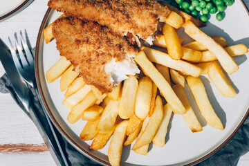 Traditional English Food such as Fish and Chips with green peas served in the Pub or Restaurant
