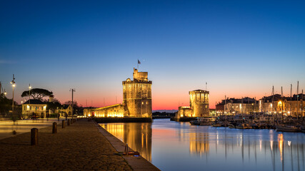 Panoramic view of the old harbor of La Rochelle at blue hour with its famous old towers