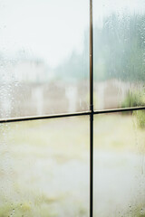 Cloudy rainy weather outside the window - blurry drops - sad mood of the house locked up