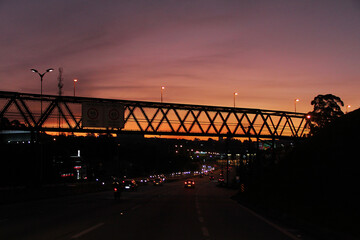 Fototapeta premium Pedestrian walkway in the backlight and sunset in the background