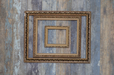 antique museum golden frame collection on old wooden wall