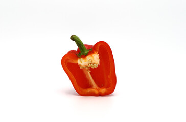 One red ripe sweet pepper in a cut on a light background. Natural product. Natural color. Close-up.
