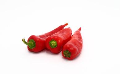 Three red ripe sweet peppers on a light background. Natural product. Natural color. Close-up.