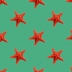 Red seastar seamless pattern isolated on green background