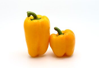 Two ripe sweet yellow pepper on a light background. Natural product. Natural color. Close-up.