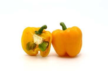 Sweet yellow pepper whole and in a cut on a light background. Natural product. Natural color. Close-up.