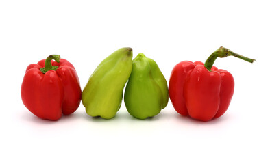Four sweet ripe red and green peppers on a light background. Natural product. Natural color. Close-up.