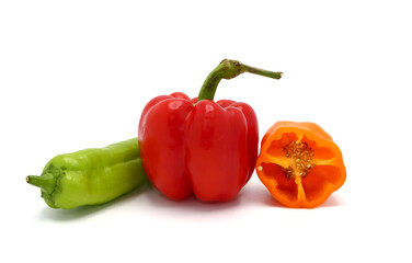 Composition of several sweet peppers and their halves of different colors on a light background. Natural product. Natural color. Close-up.