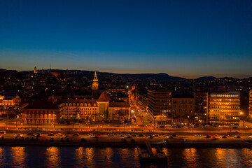 Aerial drone shot of St. Francis parish church by Danube in Budapest twilight