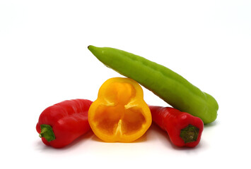 Four sweet ripe peppers of red, green and yellow color on a light background. Natural product. Natural color. Close-up.