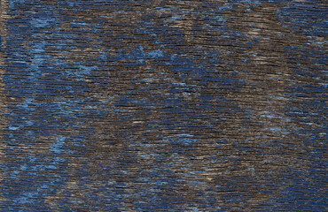 Faded blue paint on a wooden background. Wood texture and paint. The pattern of the grain of the...