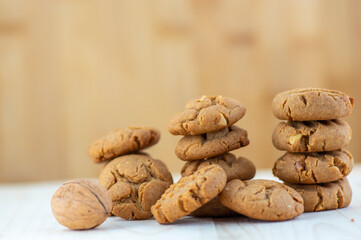 Very tasty peanut butter biscuits on bamboo light brown wooden board, golden baked healthy