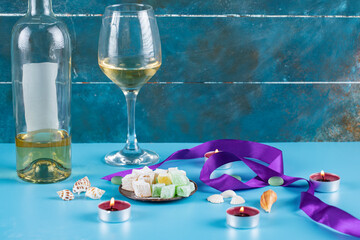 Turkish delight lokum in a metallic saucer with a glass of wine