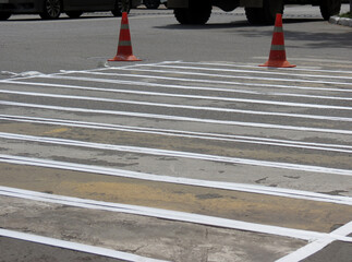 Repair work on the road. Pedestrian crossing and orange signal cones at a pedestrian crossing